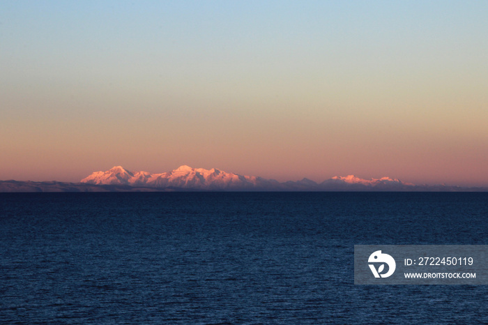 Cordillera real mountain range at sunset behind Titicaca lake, view from the peruvian side.