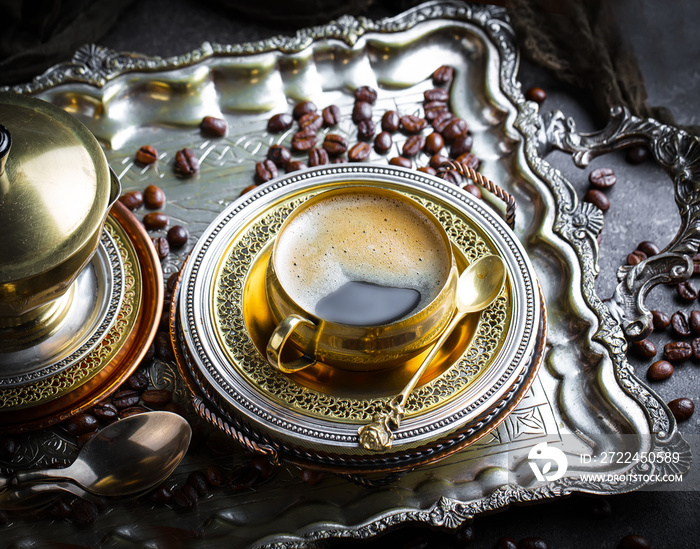 Black coffee in a cup on old background