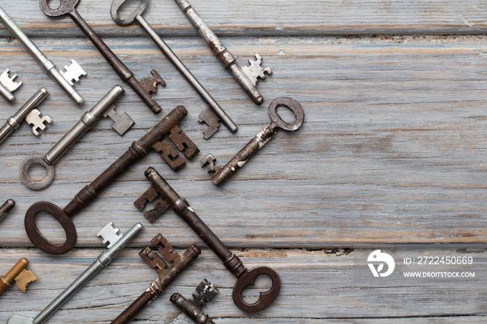 Vintage old fashioned keys on a rustic wooden background. Security concept