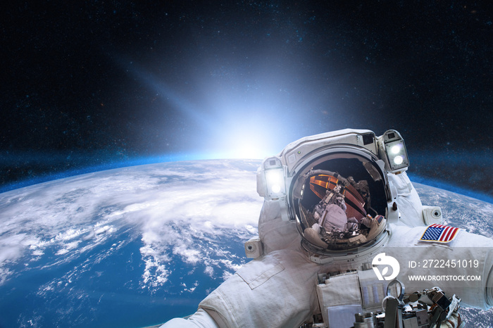 Astronaut in outer space on background of the Earth. Elements of this image furnished by NASA.