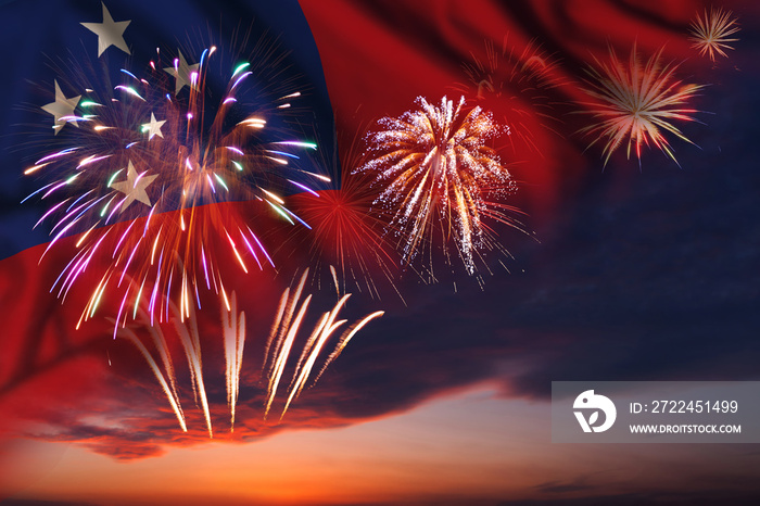 Fireworks in evening sky and flag of Samoa