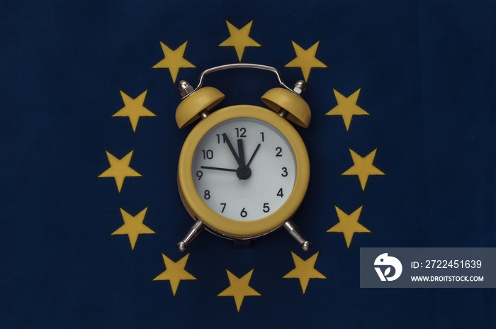 Yellow mini alarm clock on EU flag