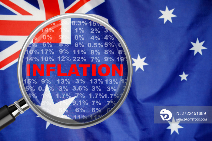 Magnifying glass focused on the word inflation on Australia flag background. Hike interest rate. Inflation income crisis. Inflation, tax, cash flow and another financial concept in Australia