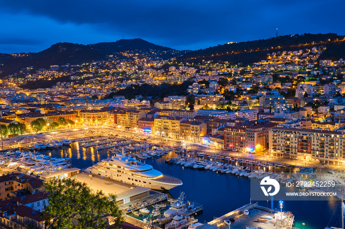 View of Old Port of Nice with luxury yacht boats from Castle Hill, France, Villefranche-sur-Mer, Nice, Cote d’Azur, French Riviera in the evening blue hour twilight illuminated