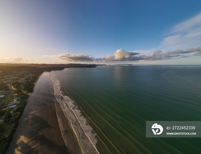 Aerial view of Orewa Beach in New Zealand through golden hour