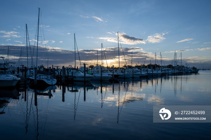 Boats docked at Dinner Key Marina in Coconut Grove, Miami, Florida in early morning light.