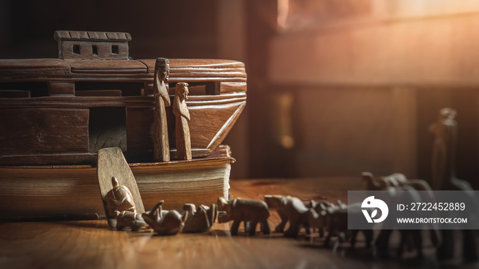 Noah’s Ark with animals entering before great flood, story in Bible, Wood carving doll, christian concept.