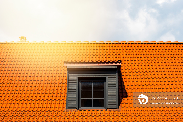 Dormer window on the red clay ceramic tiles roof