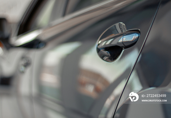 Close up photo of grey car door handle in autoshow