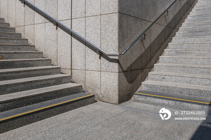 View of empty public staircase on the landing at the corner between meeting point of two staircase.