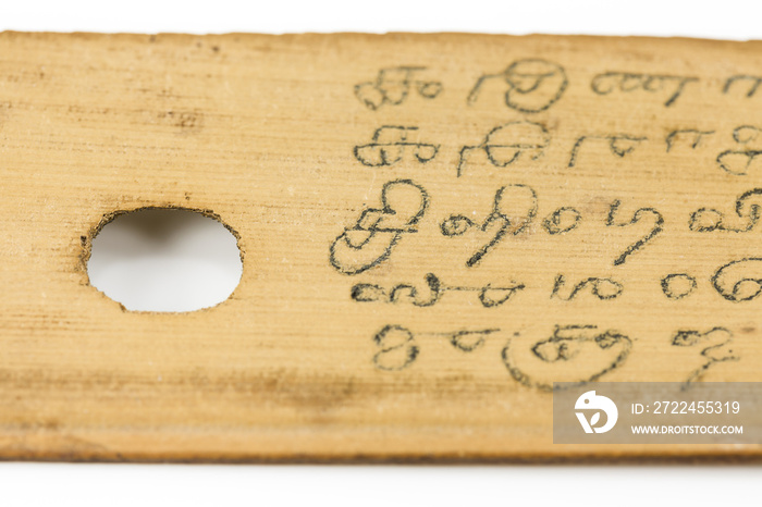 detail of a preserved palm leaf (borassus flabellifer) manuscripts showing writings about ayurvedic medicines in old malayalam script from Kerala, India