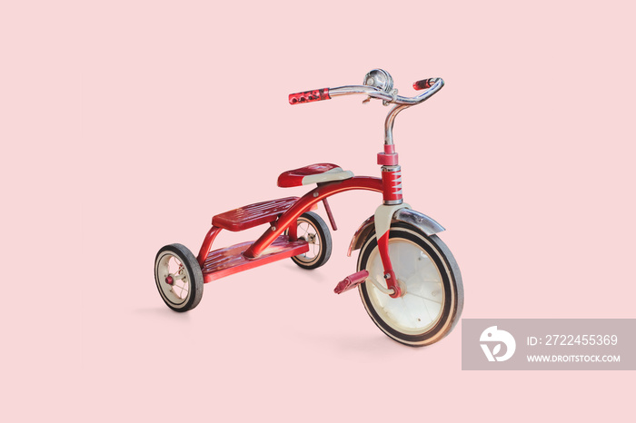 vintage kid red Tricycle on color background.