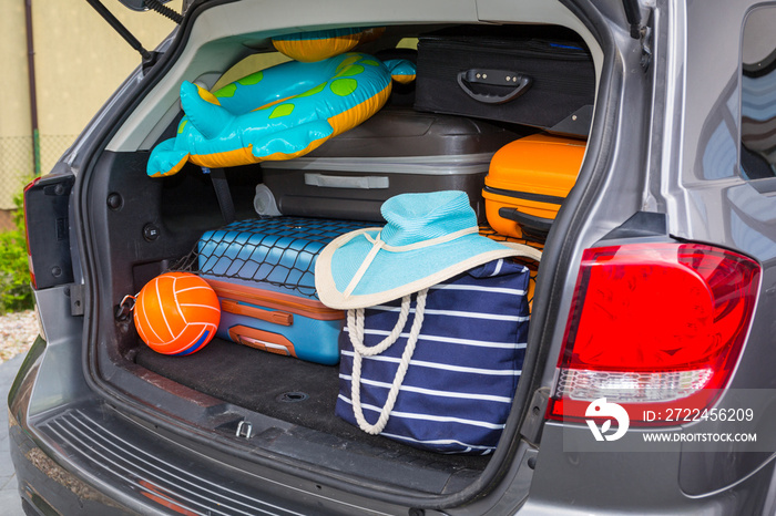 Baggages in the car trunk packed and ready to go for holidays