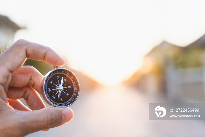 man holding compass on blurred background. for activity lifestyle outdoors freedom or travel tourism and inspiration backpacker alone tourist travel or navigator image.