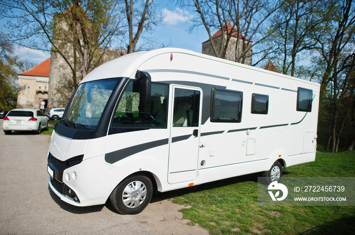 Motorhome RV camper van at parking against castle.