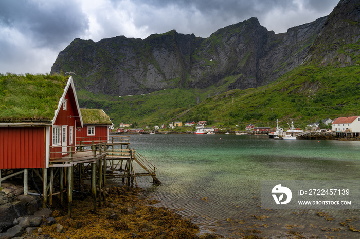 colorful red wooden houses on stilts in the fjord in Moskenes in the Lofoten Islands of Norway