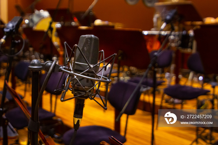 Microphone with a stand close up. Musical instruments of the Orchestra in philharmonia.