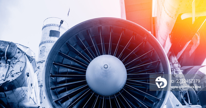 Closeup detail of turbine airplane engine blades. Blue color tone with sunlight