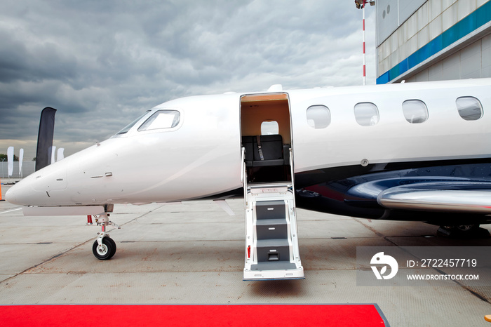 Ladder with open door in business jet airplane