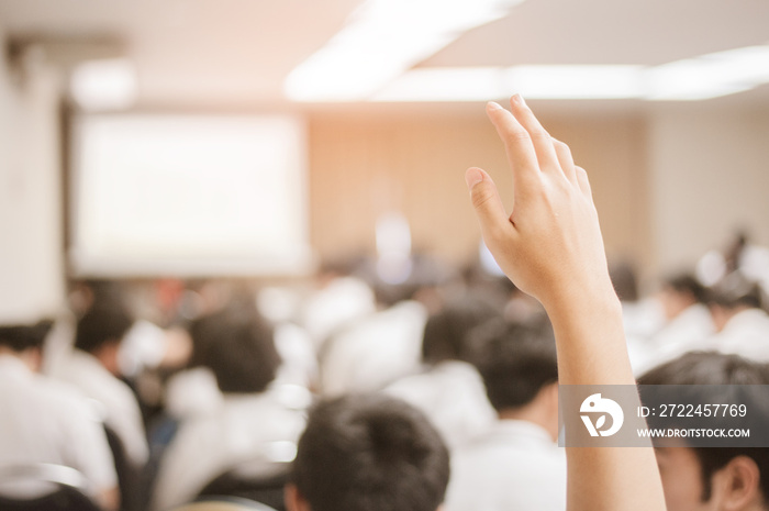 businessman raising hand during seminar. Businessman Raising Hand Up at a Conference to answer a question.