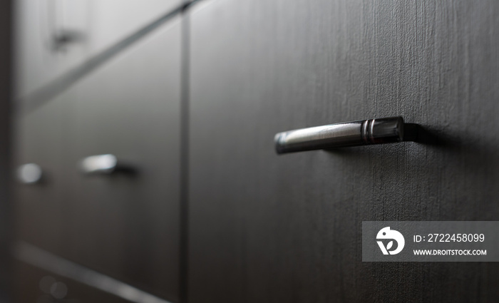 Drawer Cabinets with metal handles - extremely narrow selective and soft focus. Focus is on one of the metal handles