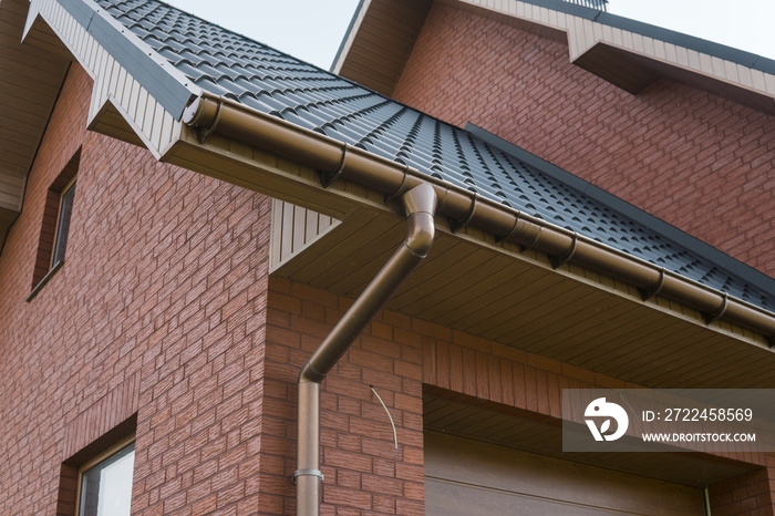 Modern roof covered with tile effect PVC coated brown metal roof sheets.