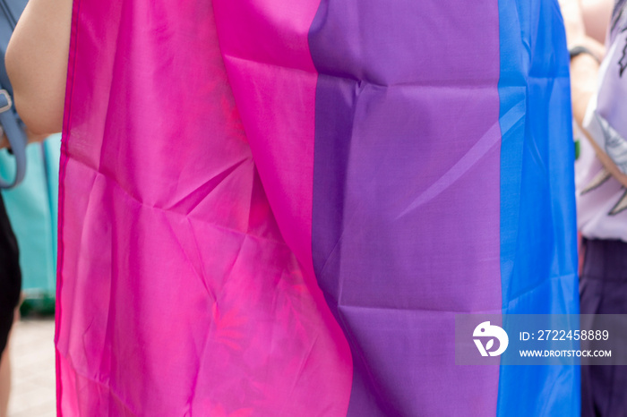 Person holding bisexual flag