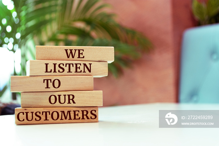 Wooden blocks with words ’We listen to our customers’. Business concept