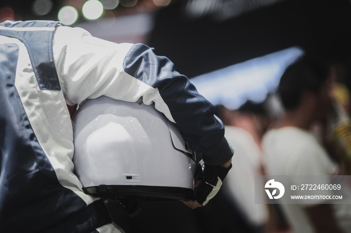 Racers hold helmets In the award ceremony. Selective focus.