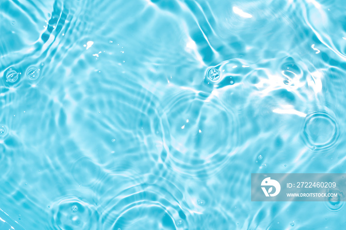 Transparent blue colored clear water surface texture with splashes. Trendy abstract nature background