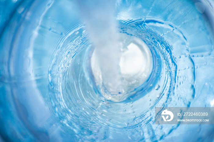 Background with a flowing stream of blue clear liquid