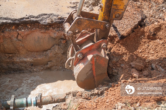 Excavator, bulldozer work a hole the repair of pipe water