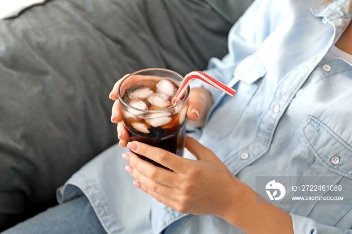 Woman drinking tasty cola at home