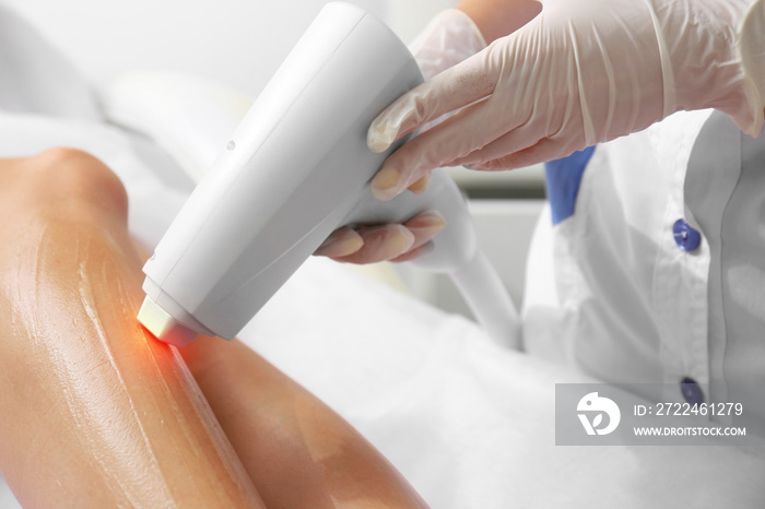 Woman getting laser treatment  in a beauty salon, close up