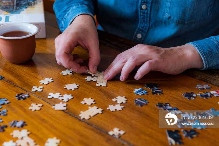 Building a jigsaw puzzle while staying at home during coronavirus lockdown