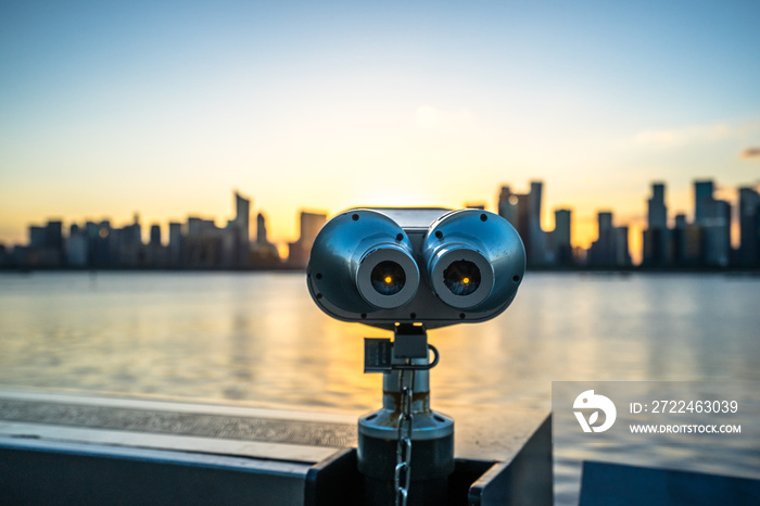 telescope with city skyline