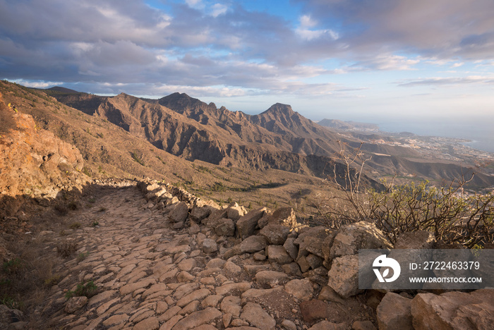 Tenerife mountain landscape. Trekking path. Adeje and Las Americas coastline in the background.