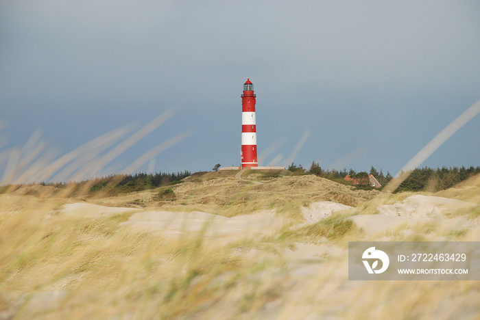 Beautiful dune landscape with traditional lighthouse on the island of Amrum at North Sea, Schleswig-Holstein, Germany