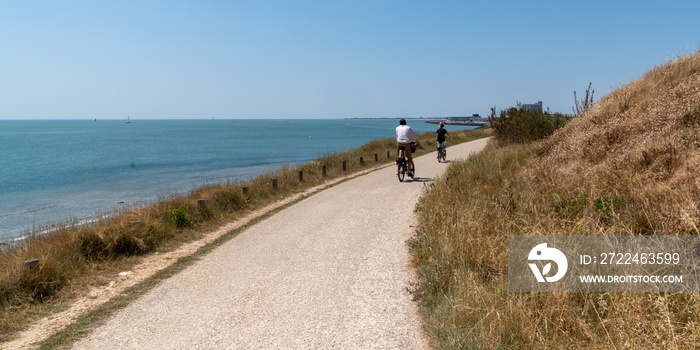 tourist family in bike vacation on the island of ile d’Aix Charente maritime in web banner template