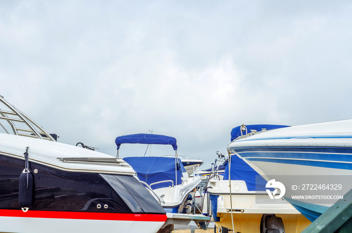 Boat on stand on the shore, close up on the part of the yacht, luxury ship, maintenance and parking place boat