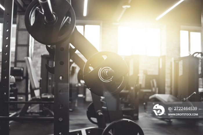 Gym equipment. Dark Gym with barbells on rack. Fitness workout center. Sport concept.