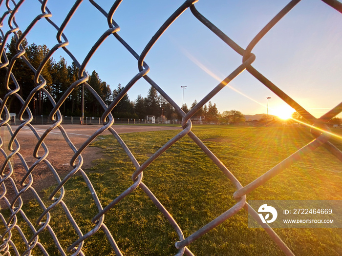 sunset baseball field chain link fence closeup afternoon sports ballpark park sport fields athletics fencing