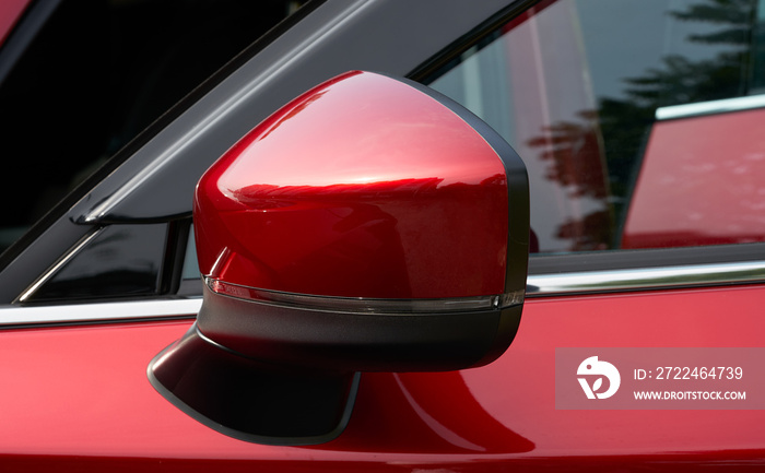 Close up of the side mirror of a red car