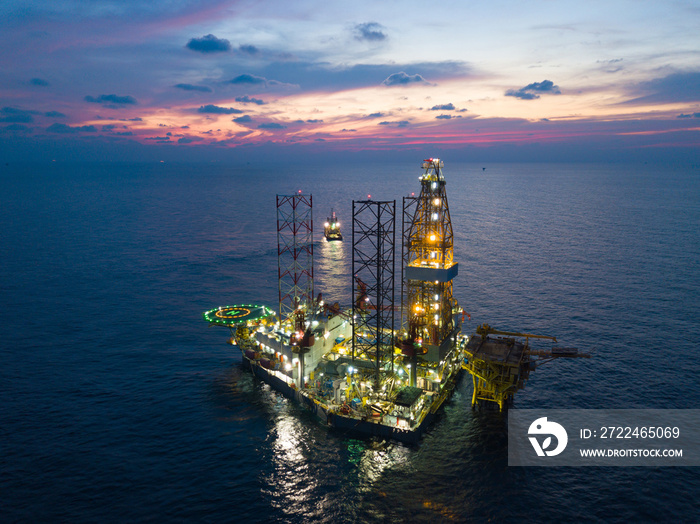 Offshore Jack Up Rig in The Middle of The Sea at Sunset Time for Petroluem Exploration and Production