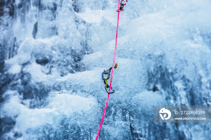 Ice Screw with Carabine and Rope used for Ice Climbing