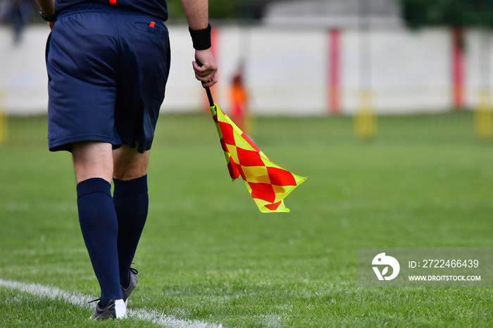 Assistant referee or Lineman of football or soccer holding flag