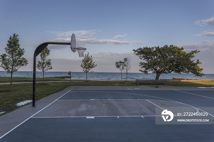 Basketball court with lake and sky