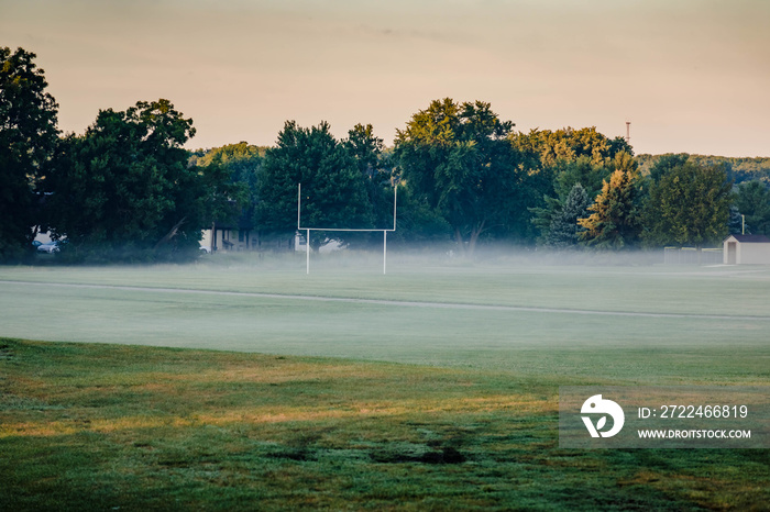 fog over the football field at the middle school at sunrise