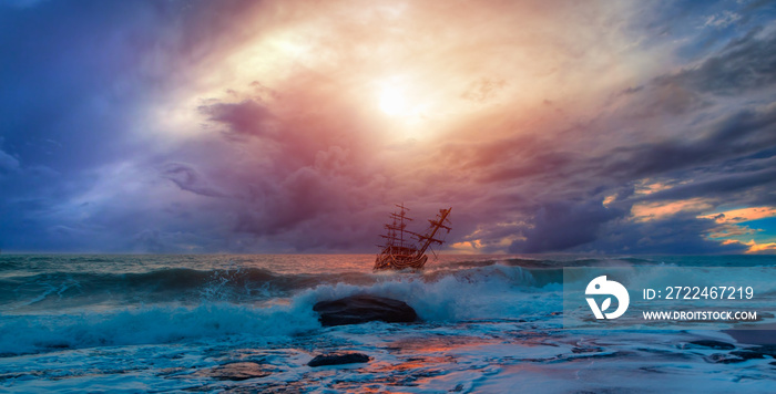 Sailing ship in storm sea against heavy sunset clouds