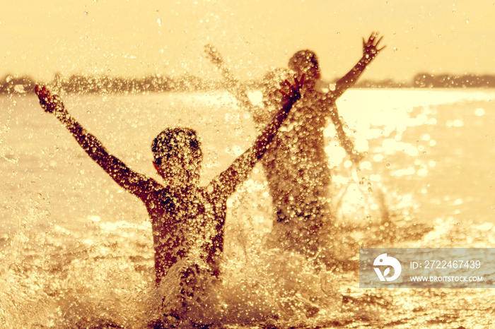 Jumping in the water. Kids have fun and splash in the water. Summer holiday concept